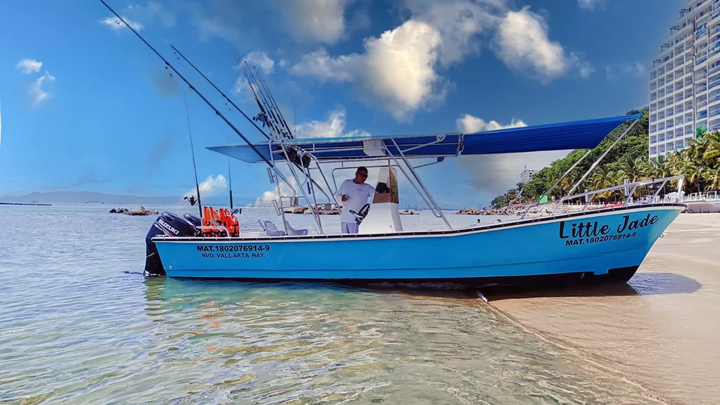 Little Jade Nava center console boat on the beach in Puerto Vallarta with fishing rods and a large shade canopy