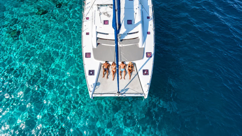 Aerial view of guests relaxing on a sailing catamaran during a luxury sailing experience in Puerto Vallarta