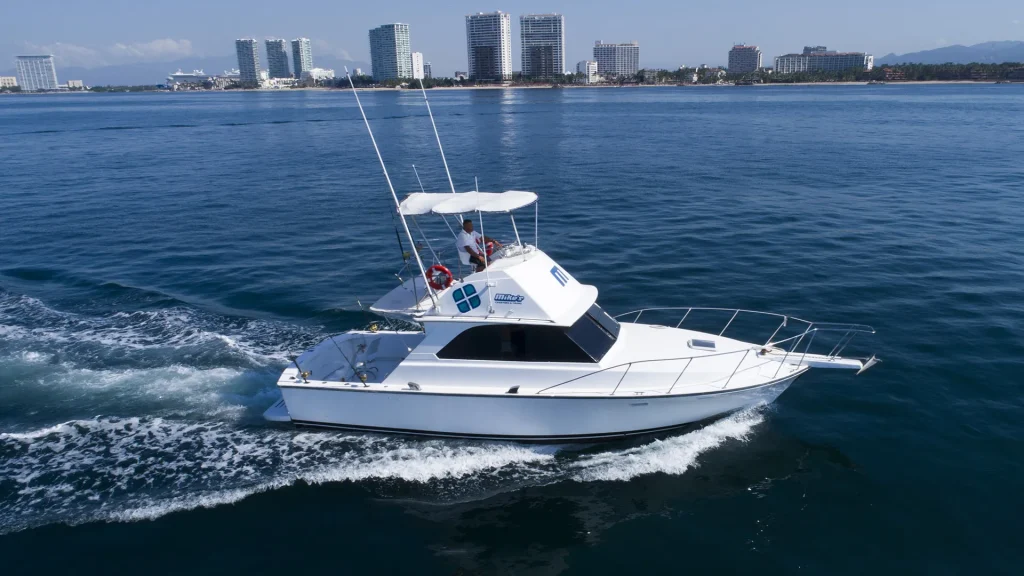 Nicolle 38-foot Bertram-style fishing boat cruising Banderas Bay off Puerto Vallarta
