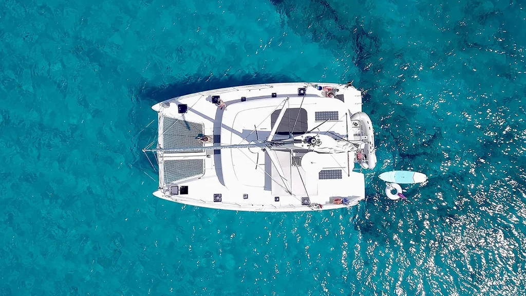 Aerial view of the GOA 42-foot Lagoon catamaran anchored in the turquoise waters of Banderas Bay, Puerto Vallarta.