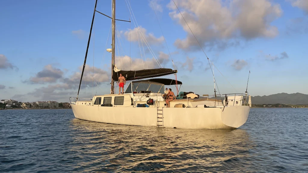 Rainbow 73-foot sailing yacht anchored on Banderas Bay near Puerto Vallarta in golden evening light