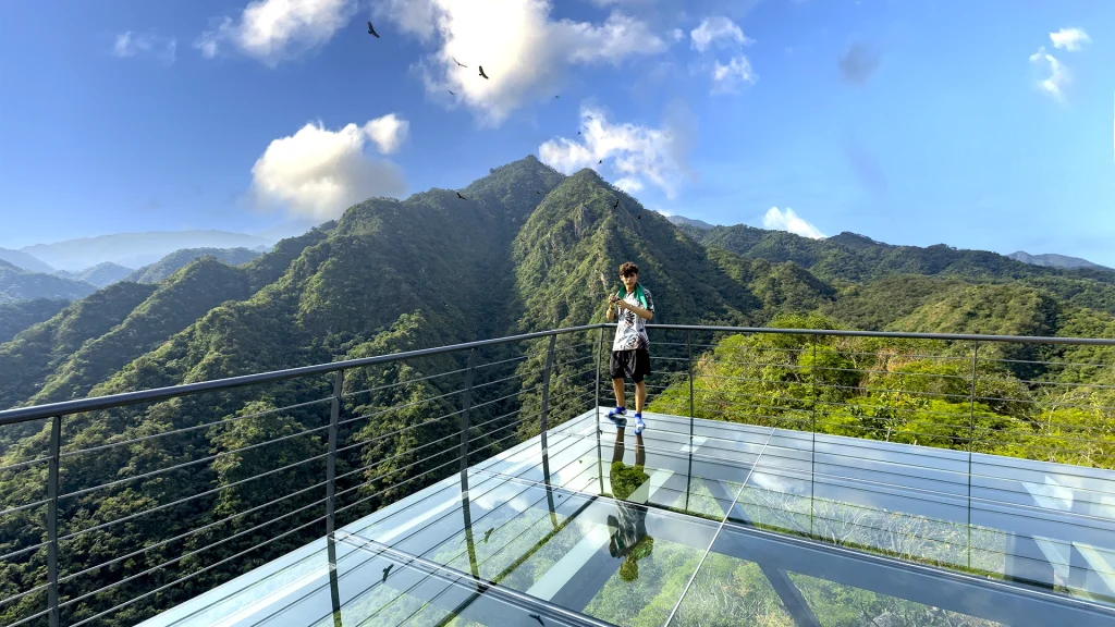 Hiker on the Jorullo Point glass observation platform overlooking the Sierra Madre near Puerto Vallarta